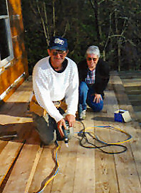 Bill and Vicky Take a Break on the Future Porch of the Cabin in the Orchard