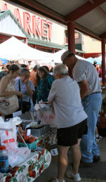 Bill and Vicky serve customers buying fruit from The Orchard at the North Market in Columbus Ohio